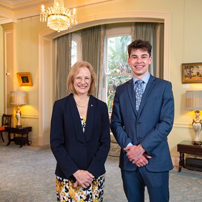 A woman and a man standing side-by-side smiling